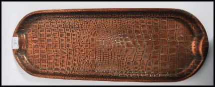 A 20th century Arts and Crafts embossed copper twin handled tray, stamped JS&S to verso