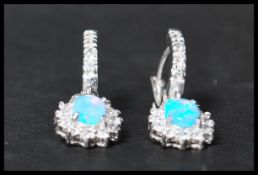 A pair of 925 silver CZ and opal drop earrings having latch backs. Marked 925.