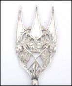 An unusual 19th century silver plated bread fork being pierced and engraved with royal crown and