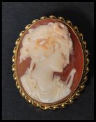 A hallmarked 9ct gold shell cameo brooch with maiden facing left with pin to verso. Weighs 6.7