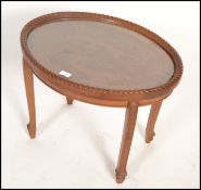 An unusual early 20th century Chinese carved side table. Raised on shaped legs with oval table top
