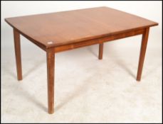 William Lawrence - A 1970's retro large teak rectangular extending leaf table having a flip out leaf