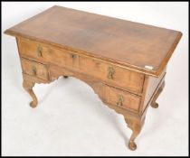 An 18th century Queen Anne walnut lowboy desk of large form. Raised on cabriole legs with pad feet