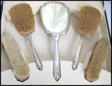 A stunning Art Deco silver hallmarked silver five piece dressing table set. The matching set