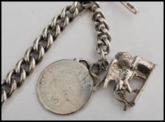 A silver hallmarked fob chain with attached fob medals, each link stamped with a contemporary full