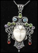 A 925 silver Art Nouveau style pendant necklace strung with figural pendant of a lady set with