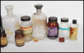 A collection of vintage mid 20th century glass apothecary bottles of various signs and form, some