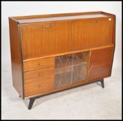 A 1950's - mid century retro sideboard - highboard having a series of fall front cabinets over