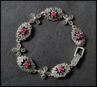A 925 silver  Art Nouveau style bracelet set with ruby cabochons and marcasite having a clip