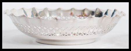 A pair of sterling silver hallmarked bon bon dishes having fret pierced surrounds. Hallmarks for