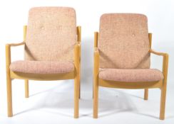 A pair of retro 20th century low Ercol staff industrial school chairs. Raised on turned supports