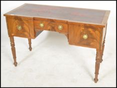 A 19th century mahogany inverted breakfront desk, tooled red leather top above a series of drawers