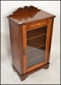 A Victorian mahogany and marquetry inlaid pier cabinet. Raised on plinth base with single door