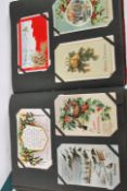 Postcards. Collection in Edwardian album of Christmas Greetings type (300). Mostly antique issues.