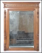 A 20th century French walnut large overmantel mirror with carved columns to the side and cornice