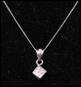 A 9ct gold and diamond pendant necklace strung with a diamond pave set pendant  on a white gold