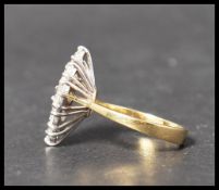 A hallmarked 18ct gold and diamond ring. The nine round cut diamond stones being approx 20pnts and