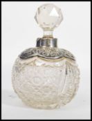 A 19th century Victorian silver hallmarked perfume bottle of globular form. The faceted glass body