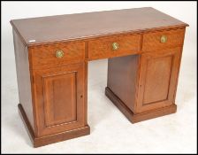 An Edwardian mahogany inlaid twin pedestal office desk. Raised on plinth bases with locker doors and