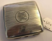 A hallmarked silver engine turned cigarette case with hidden photograph compartment.  The case