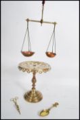 A late 19th century brass tazza / cake stand, raised on a turned base with an ecclesiastical fret