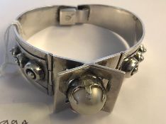 A signed Taxco Mexican modernist silver bangle bracelet set with a pearl having a clip clasp. Marked