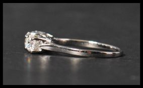 A 14ct white gold three stone diamond ring set with three diamonds in a prong setting. Diamonds