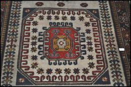 A 20th century Kelim woolen rug, on cream ground with a central medallion, inner border with