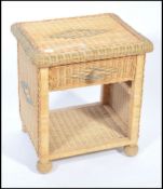 A vintage 20th century whicker occasional / side table of square form, open front with a single