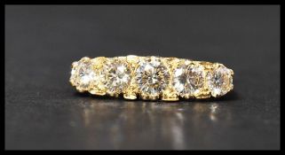 A hallmarked 18ct gold and diamond 5 stone ring having 5 graduated diamonds in a gypsy setting.