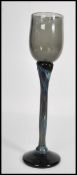 A vintage mid 20th century studio art wine glass raised on circular base with long coloured stem and
