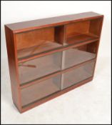 A vintage 20th century mahogany lawyers stacking bookcase cabinet of sectional form with glass facia