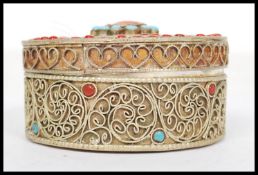 A vintage 20th century white metal / silver gilt and Turquoise trinket pot / box of circular form,
