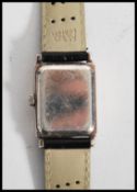 A vintage 20th century silver cased art deco wrist watch.The case of square form with silvered dial.