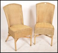 A pair of 20th century Lloyd loom style rattan weave conservatory chairs each raised on turned