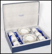 A cased set of six late 20th century bone China unused coffee cans with saucers by Aynsley in the