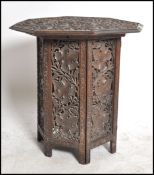 A 19th century black forest carved oak folding table of Octagonal form having carved leaf design
