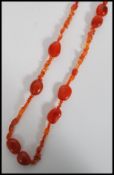A vintage orange agate stone bead necklace of varied graduating form. Measures 64cm long.