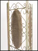 A 20th century cast and wrought metal rattan weave ladies discretionary folding screen. Green