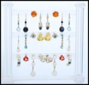 A large collection of costume jewellery earrings to include yellow and white metal examples being