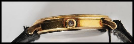 A vintage 20th century Omega Constellation swiss made wrist watch. The gilt dial having baton and