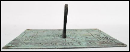 Sundial, a 19th Century ? circular bronze sundial engraved with sun motif and roman numerals  and