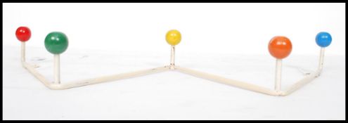A vintage retro sputnik atomic set of coat hooks in a painted white finish with multi coloured