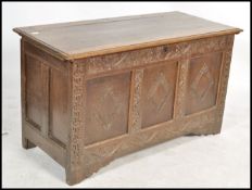 A James 1st oak country coffer being raised on reduced stile supports, 3 fielded panel front with