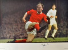 Bobby Charlton Signed Football Print a colour print depicting Charlton in an action scene, limited