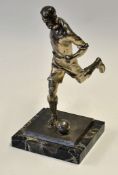 Silvered Spelter Football Figure depicting a footballer striking a ball, on a marble base,