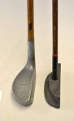 An unusual design cast metal wide sole flanged centre shaft putter fitted with early pre-war steel