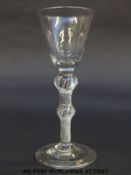 George II drinking glass with rounded funnel bowl over double knopped air twist stem raised on