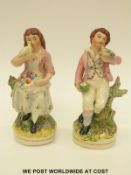 A pair of 19thC Staffordshire figures of a girl and a boy holding doves (20cm tall)