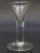 A Georgian drinking glass with elongated trumpet bowl over thick stem raised on plain foot, 12.